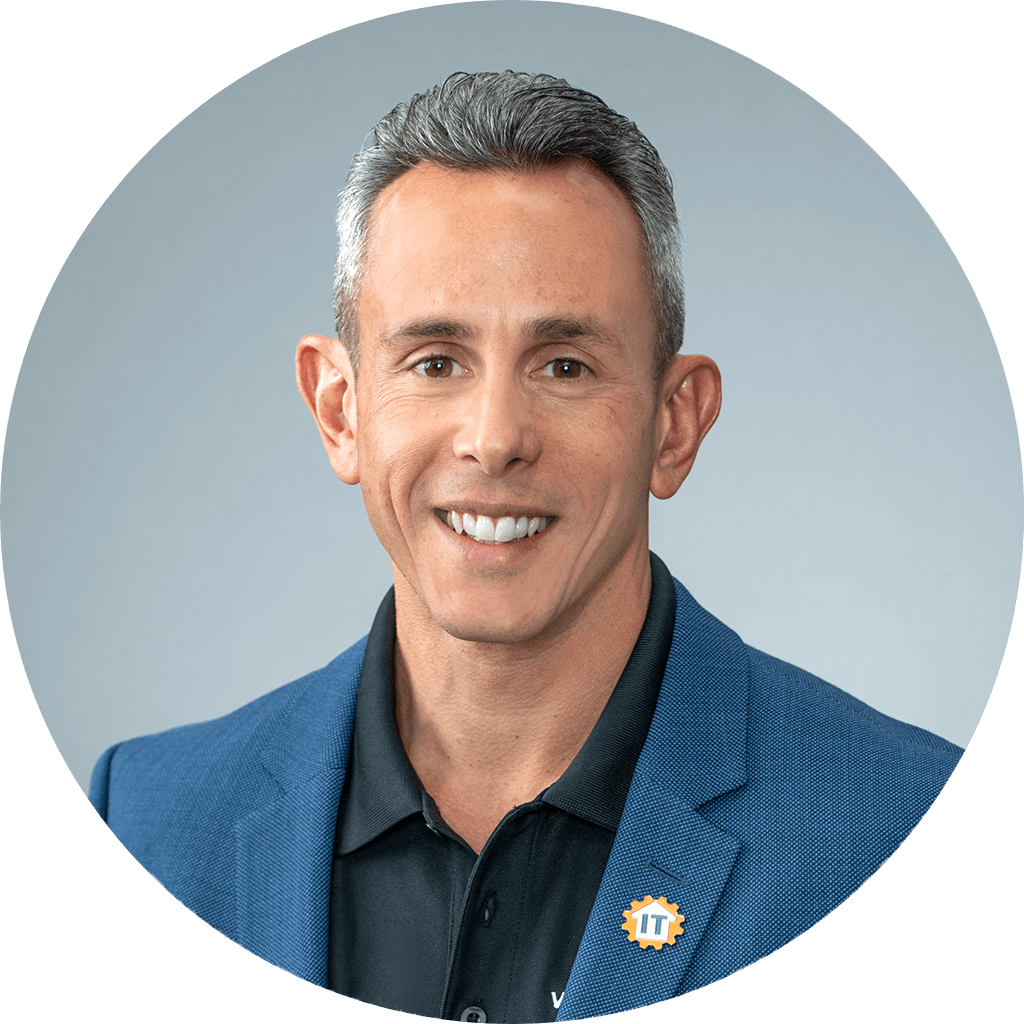 confident male professional with blue blazer and pin emblem in circular headshot.