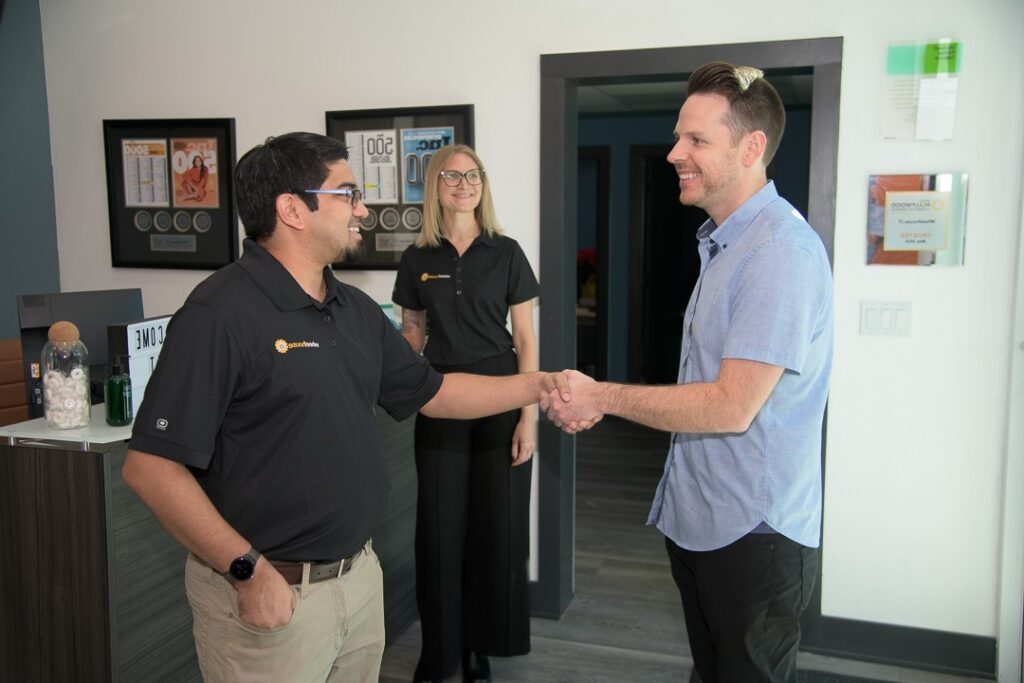 professional handshake in a welcoming office setting.