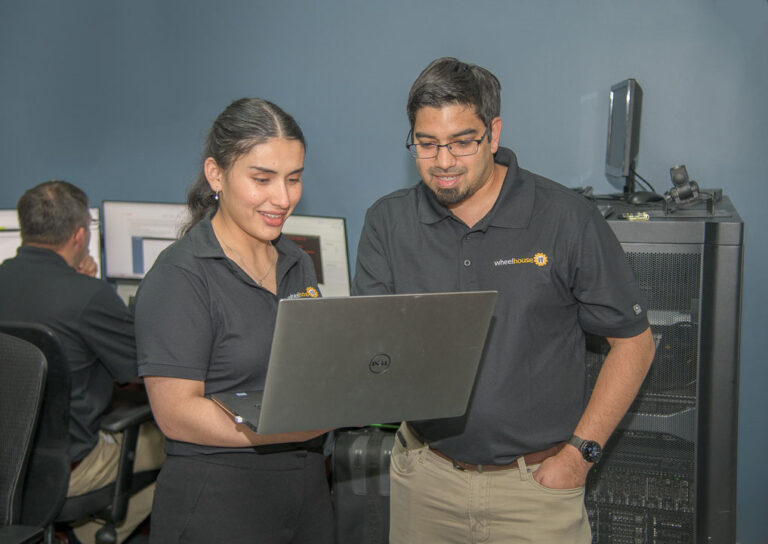 diverse professionals collaborating in tech-oriented office for wheelhouse, showcasing teamwork and innovation.