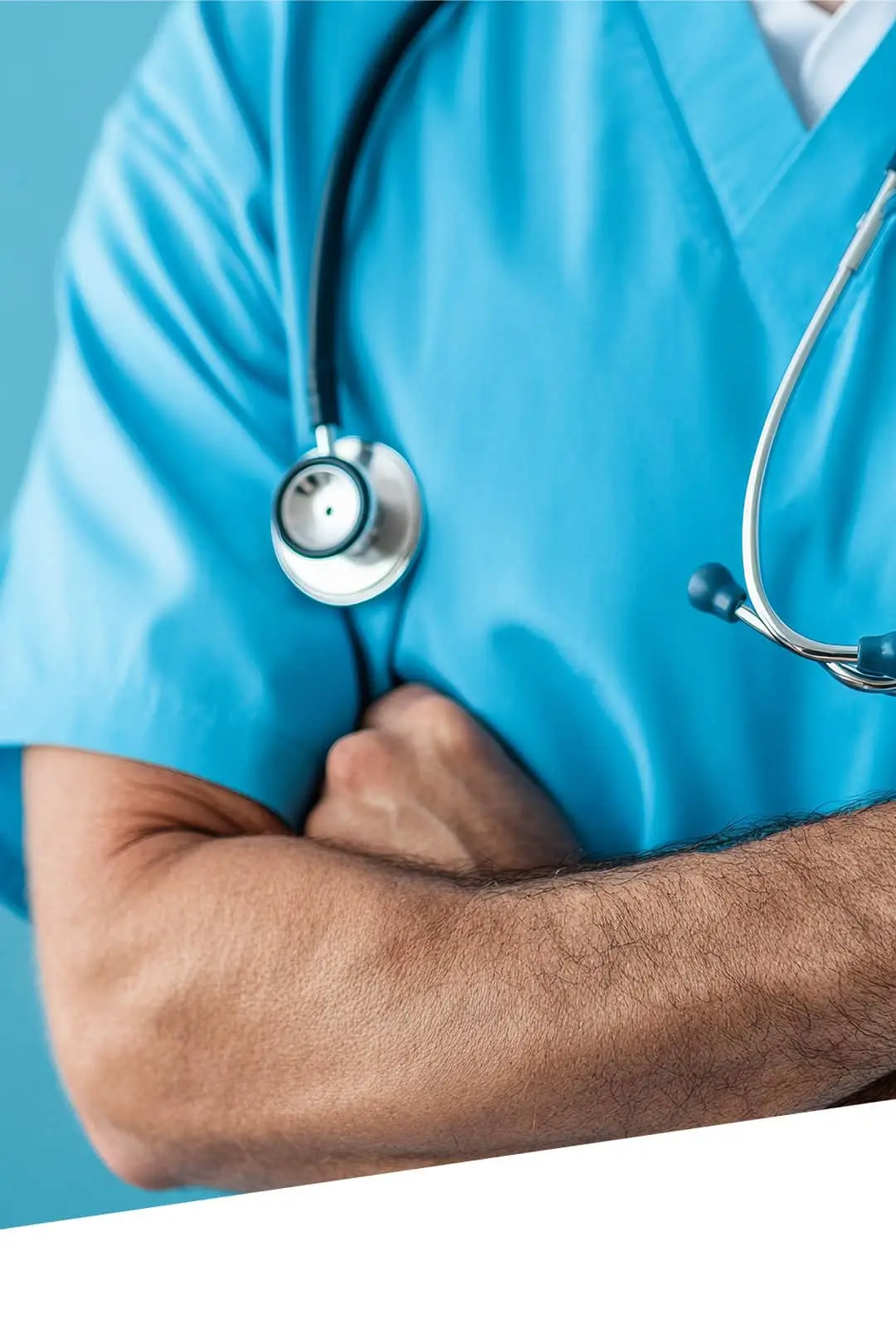 Healthcare professional in turquoise scrubs with crossed arms and stethoscope.