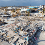 Recovery efforts in devastated coastal area after a disaster, showcasing resilience and rebuilding.