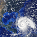 Satellite view of powerful hurricane in Gulf of Mexico, showcasing swirling clouds and eye.