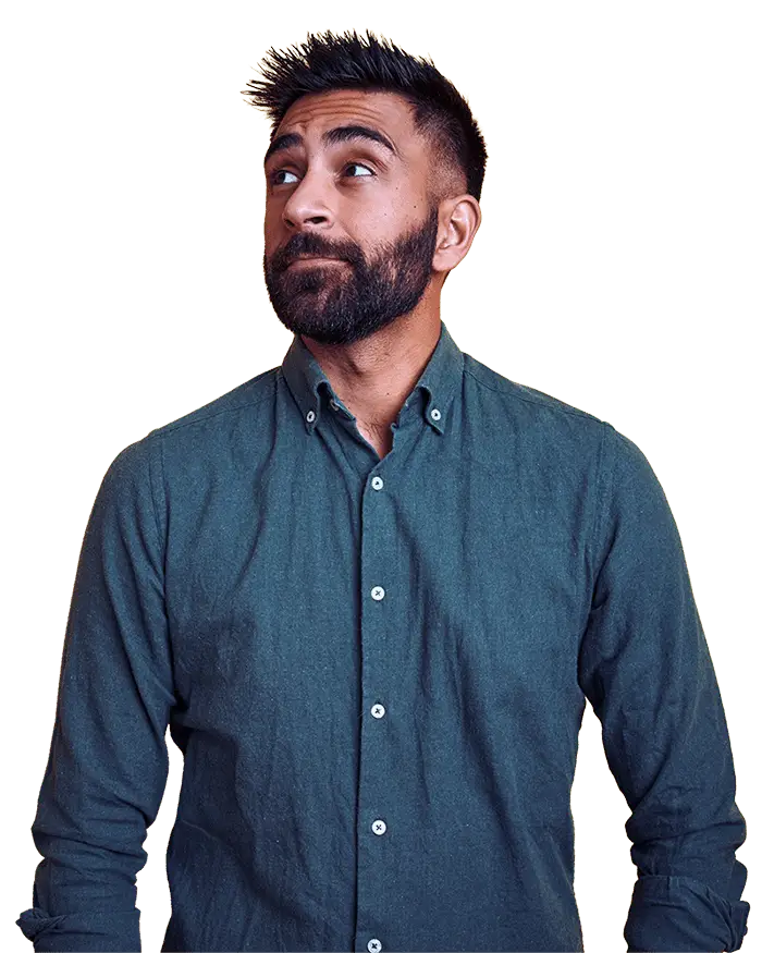 stylish man in teal shirt against bright yellow background in thoughtful pose.