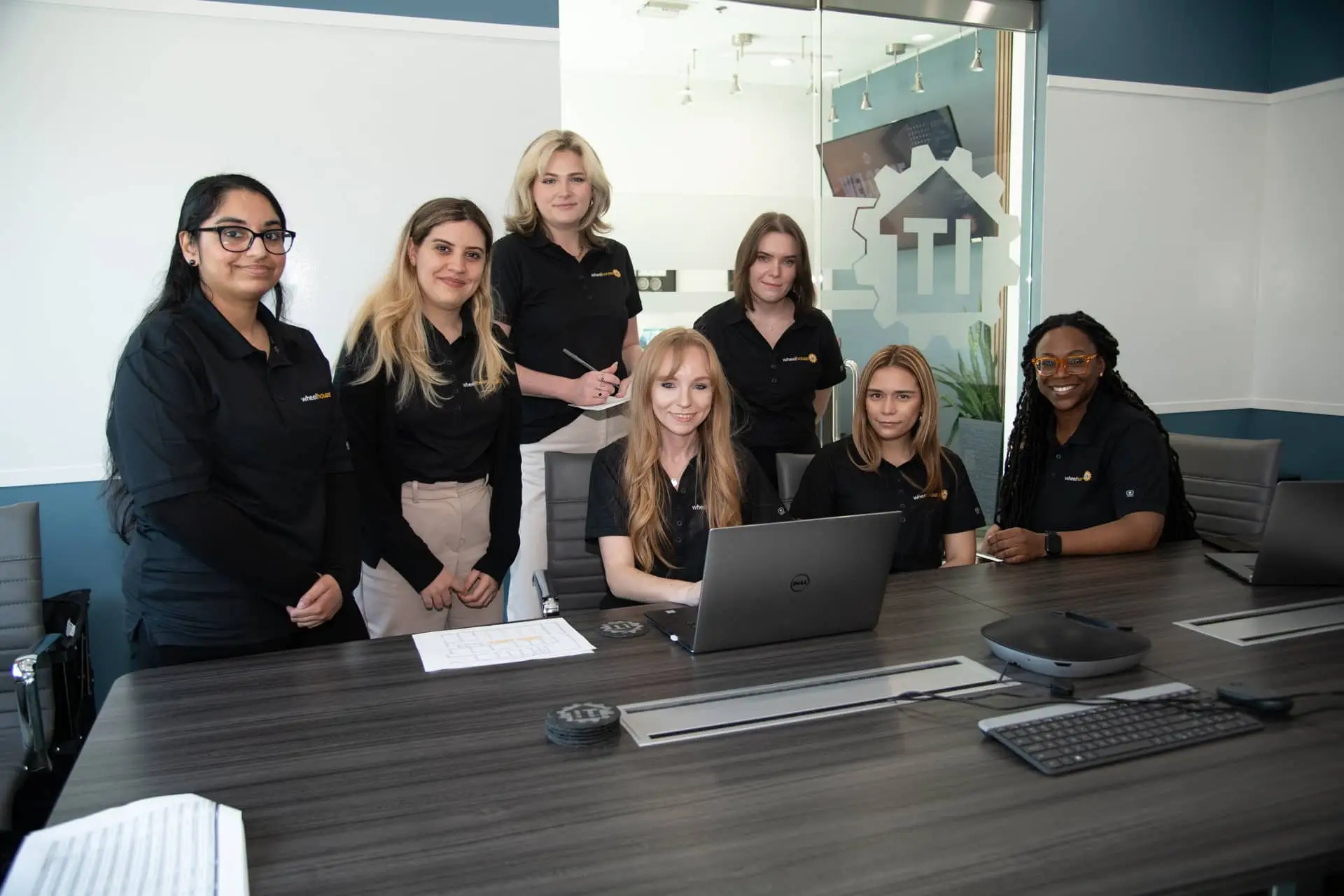 professional women team meeting in modern office with laptops and sleek design.