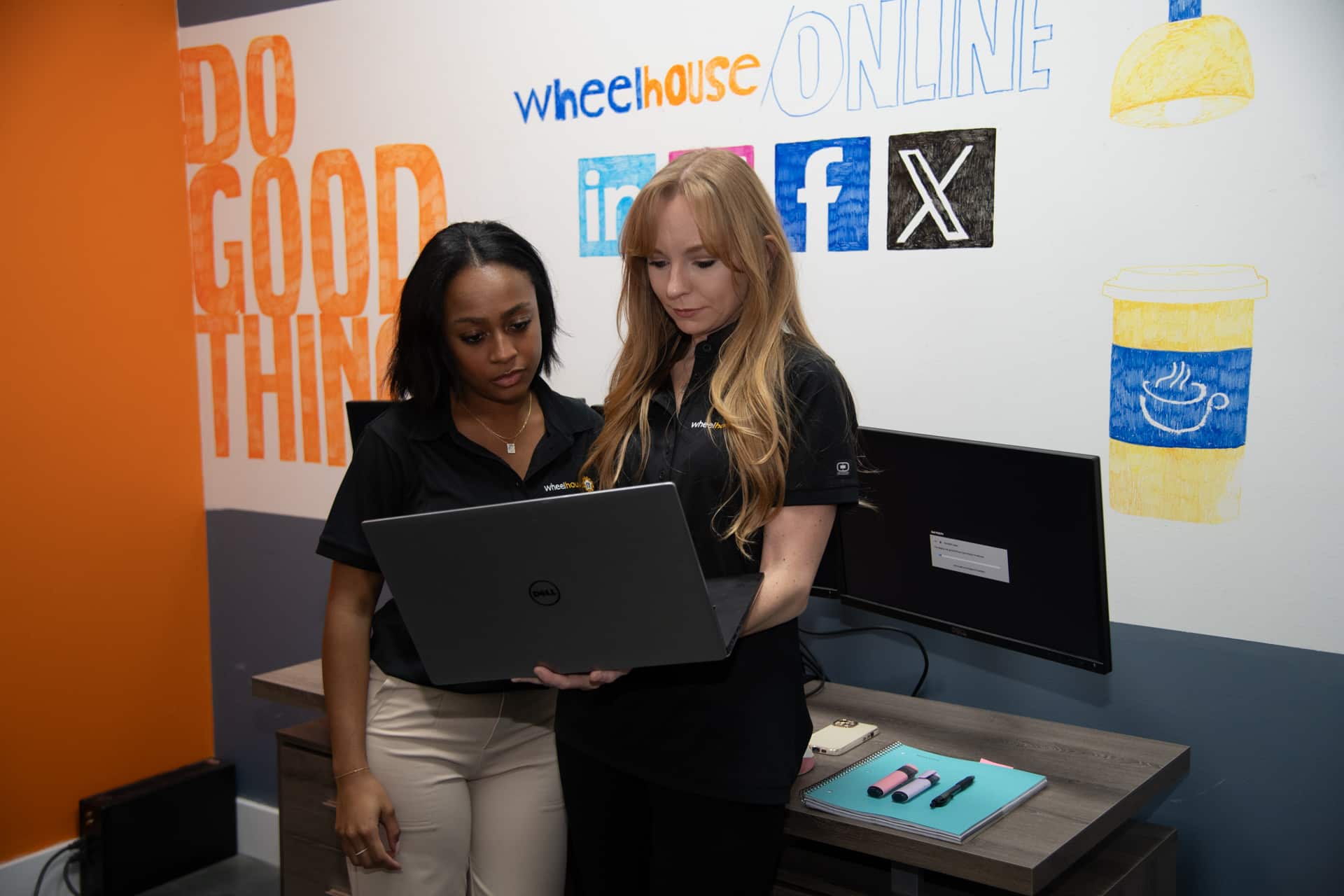 modern workplace collaboration between two women discussing on a laptop.