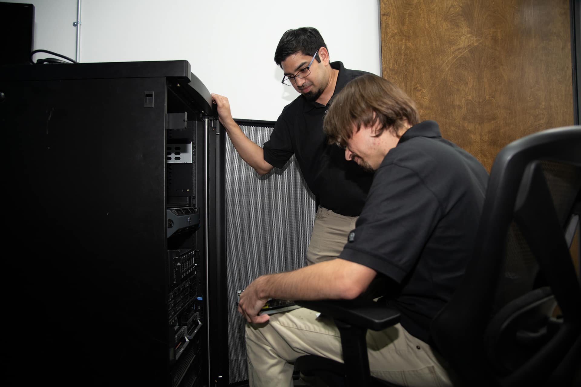 teamwork and troubleshooting on server equipment in a professional setting.