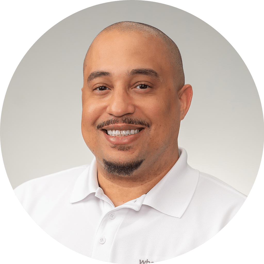 professional headshot of a friendly man in a white polo shirt for business purposes.