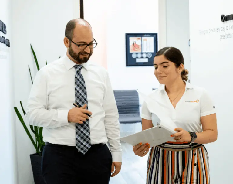 professional collaboration in modern office setting, showcasing mentorship and teamwork dynamics.