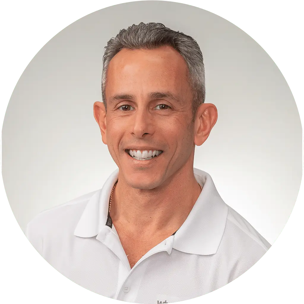 approachable man with warm smile in crisp white shirt for professional profile picture..