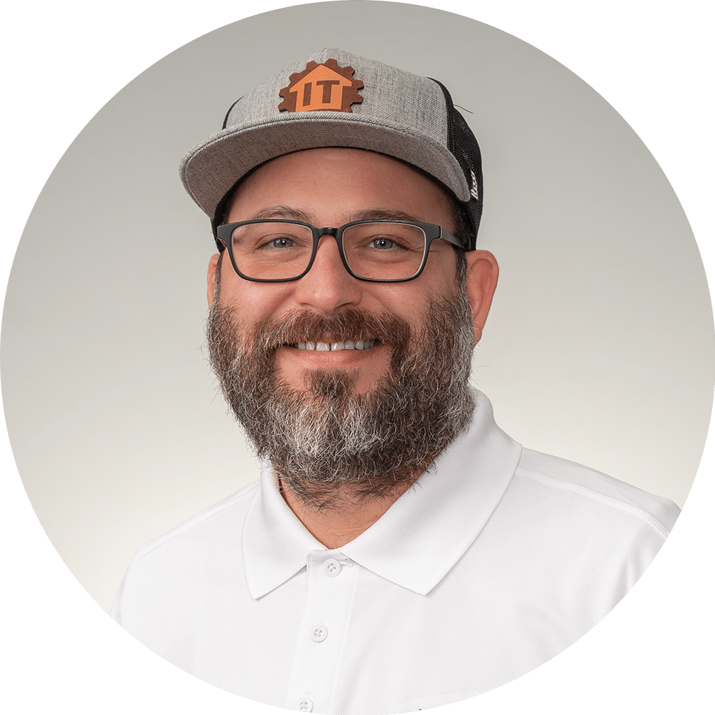 friendly man in stylish gray cap and white polo shirt, exuding approachability and expertise.