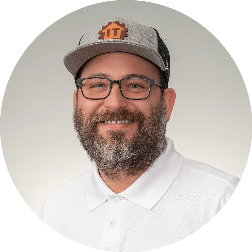 friendly man in stylish gray cap and white polo shirt, exuding approachability and expertise.