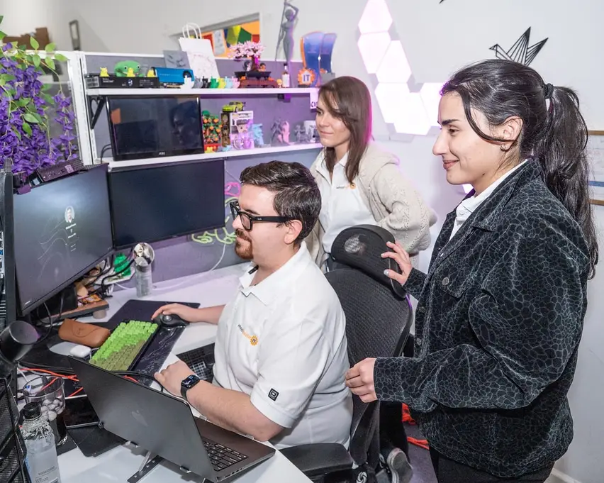 managed it services team collaborating at a dual-monitor office workstation.