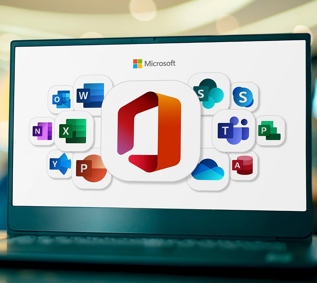 sleek laptop displaying vibrant microsoft office application icons in modern office setting.