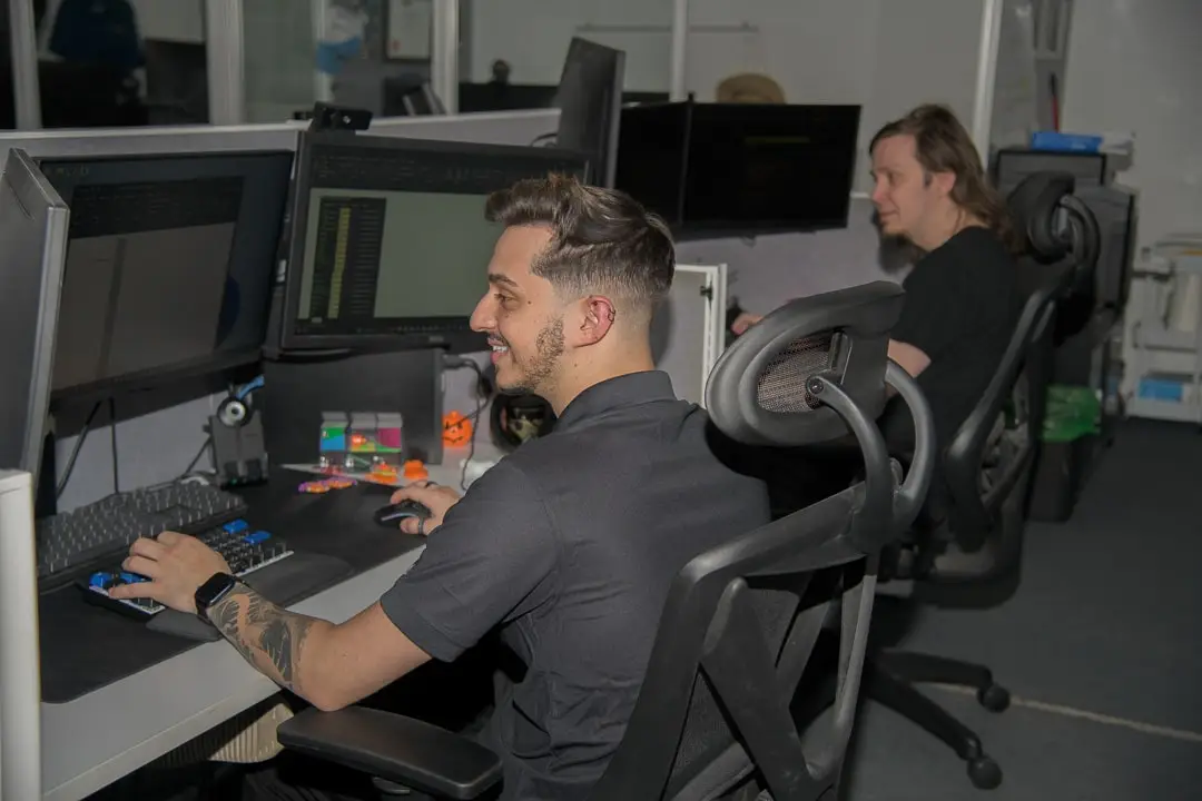 tech professionals collaborate in modern, sleek office space designed for efficiency and innovation.