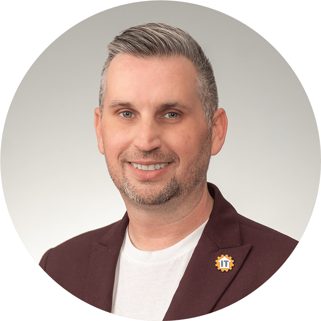 modern professional man in stylish attire with it pin, smiling against gradient background.
