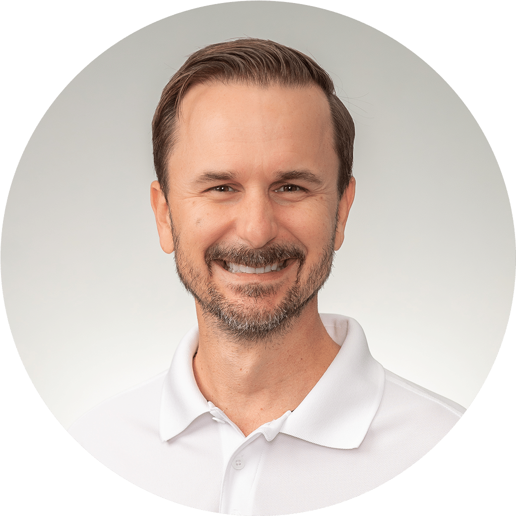 man in white polo shirt with friendly smile on gradient background.