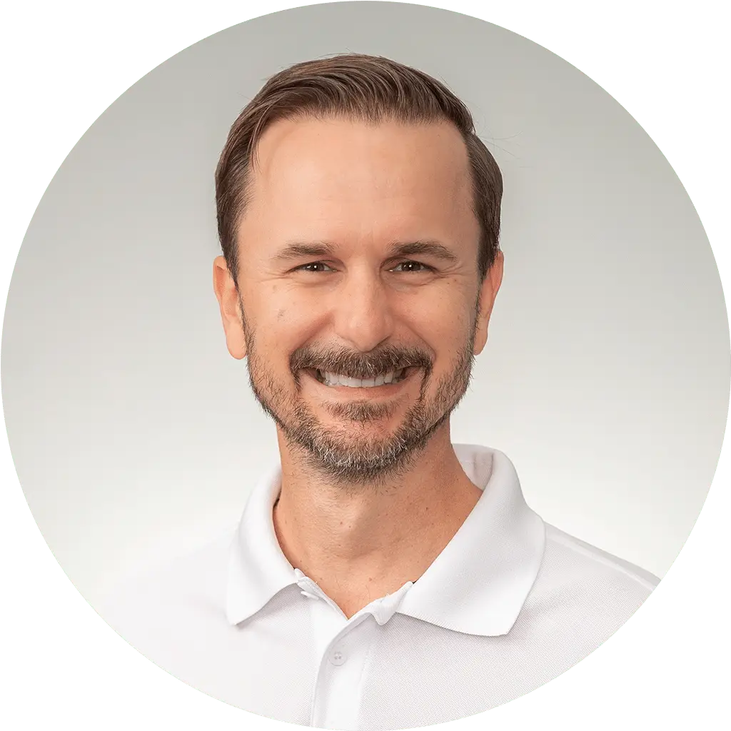 man in white polo shirt with friendly smile on gradient background.