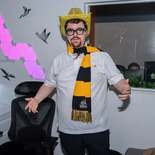young man in vibrant sports attire exuding team spirit in modern office setting.