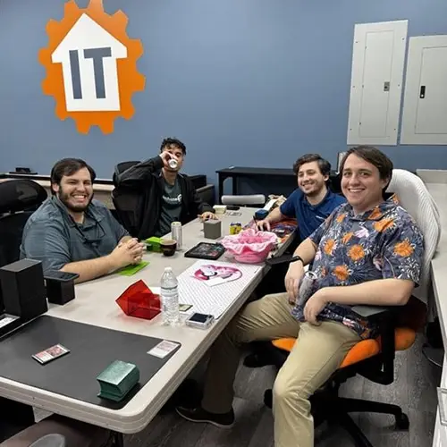 group of friends enjoying casual gaming in vibrant setting with snacks and cards.