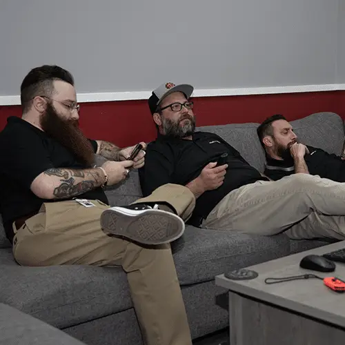 three friends lounging on a stylish couch in a cozy modern room.