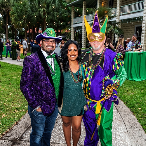 colorful cultural event celebration with vibrant outfits, palm trees, and festive decorations.