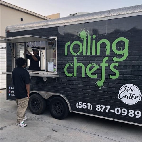 modern food truck in urban setting with vibrant design and engaged customers.