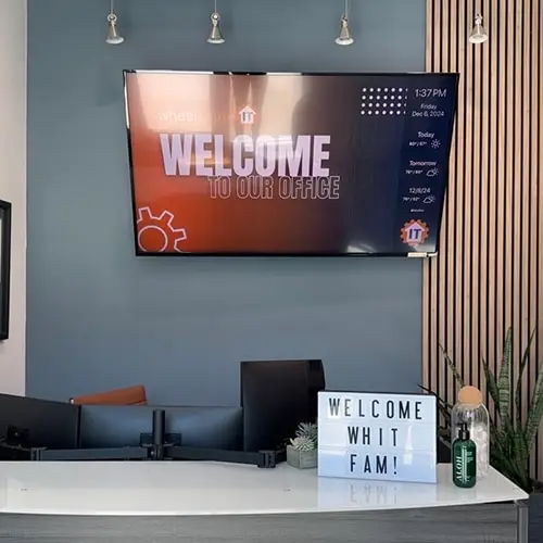 modern office reception desk with welcoming message and stylish decor for a professional setting.