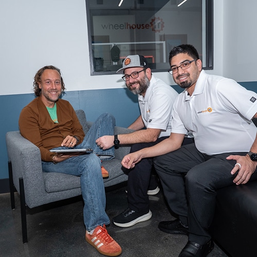 three professionals collaborating in a modern office space.,