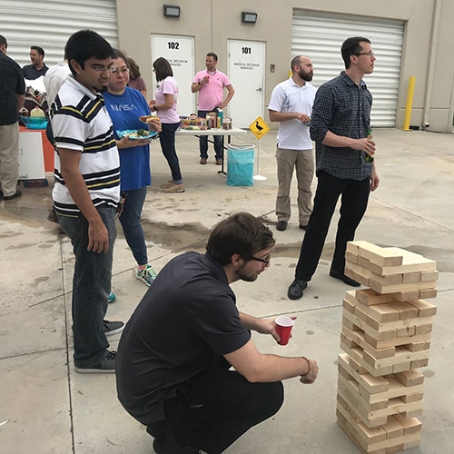 social gathering with outdoor picnic, games, and team-building activities in a casual setting.