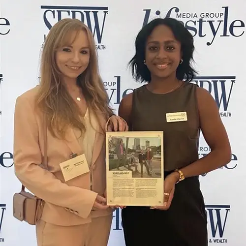 two professional women networking and celebrating success at a media event.
