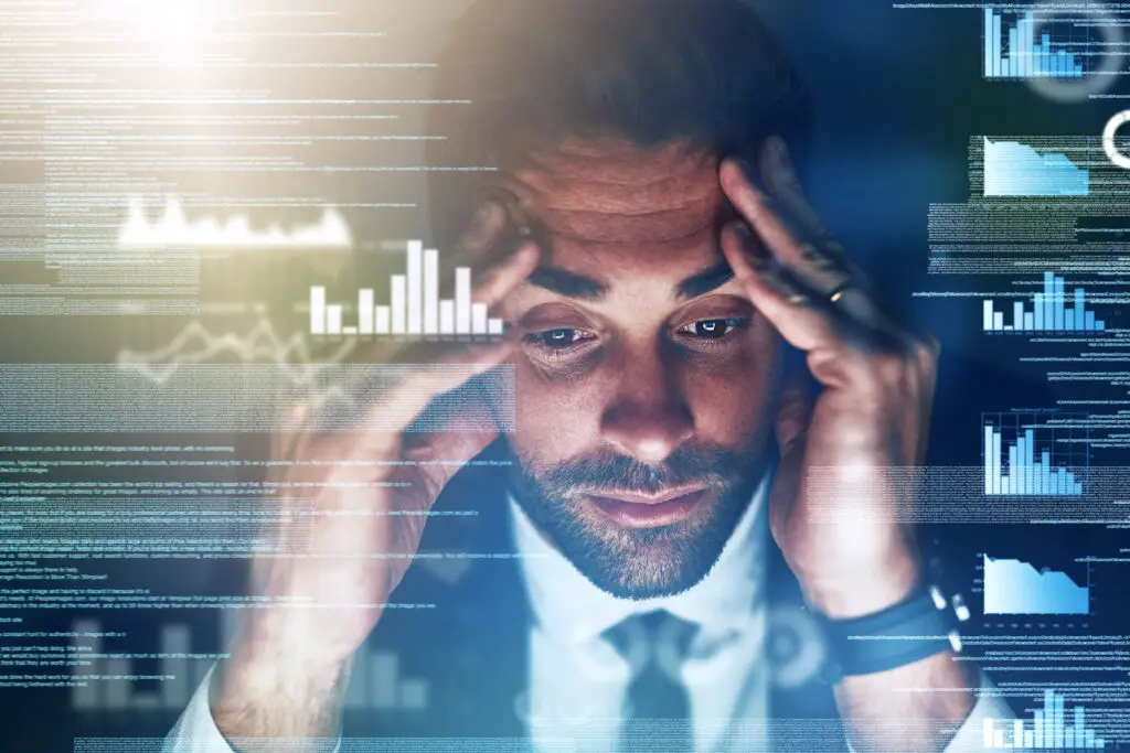 Stressed Businessman Reviews Data, Showing Signs His Business Has Outgrown Its It Setup. stressed businessman reviews data, showing signs his business has outgrown its it setup.