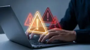 person typing on laptop with glowing biggest security risk alerts.