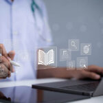 6 Best Miami IT Providers a doctor uses a laptop to manage their IT network