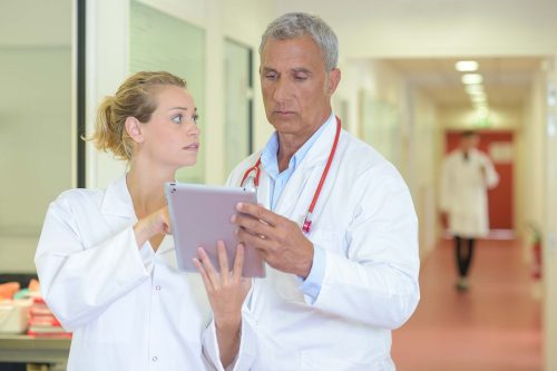 a doctor and a patient looking at something on a tablet