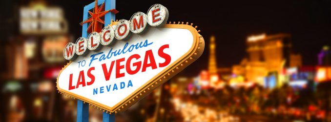 the las vegas sign is lit up at night