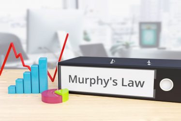 a desk with a sign that says murphy's law next to it