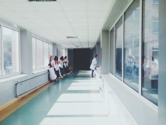 a group of people walking down a long hallway